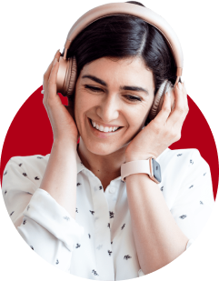 A woman wearing headphones and smiling for the camera.